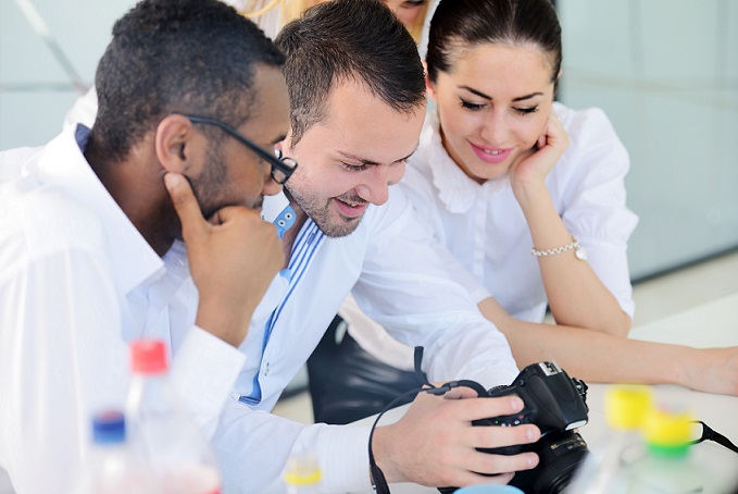 Group of business people looking at camera display